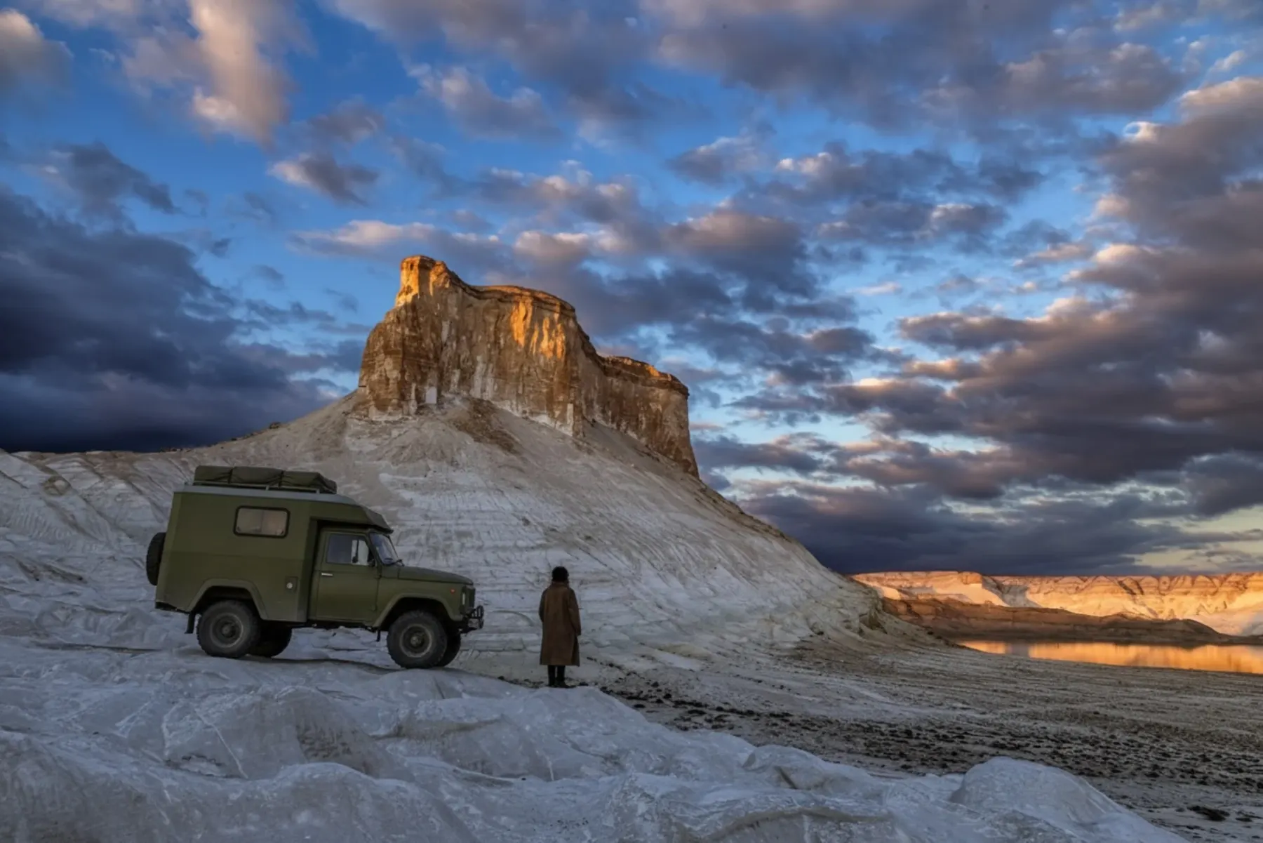 Overland camper parked on a ridge overlooking the chalk formations of Mangystau