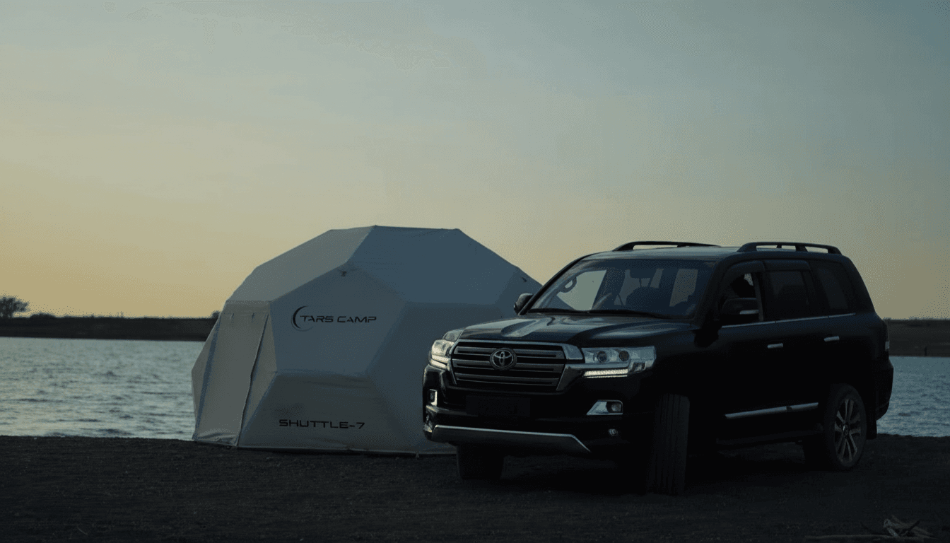 Luxury glamping geodesic dome tent at golden hour on the endless Kazakh steppe with distant Tian Shan foothills